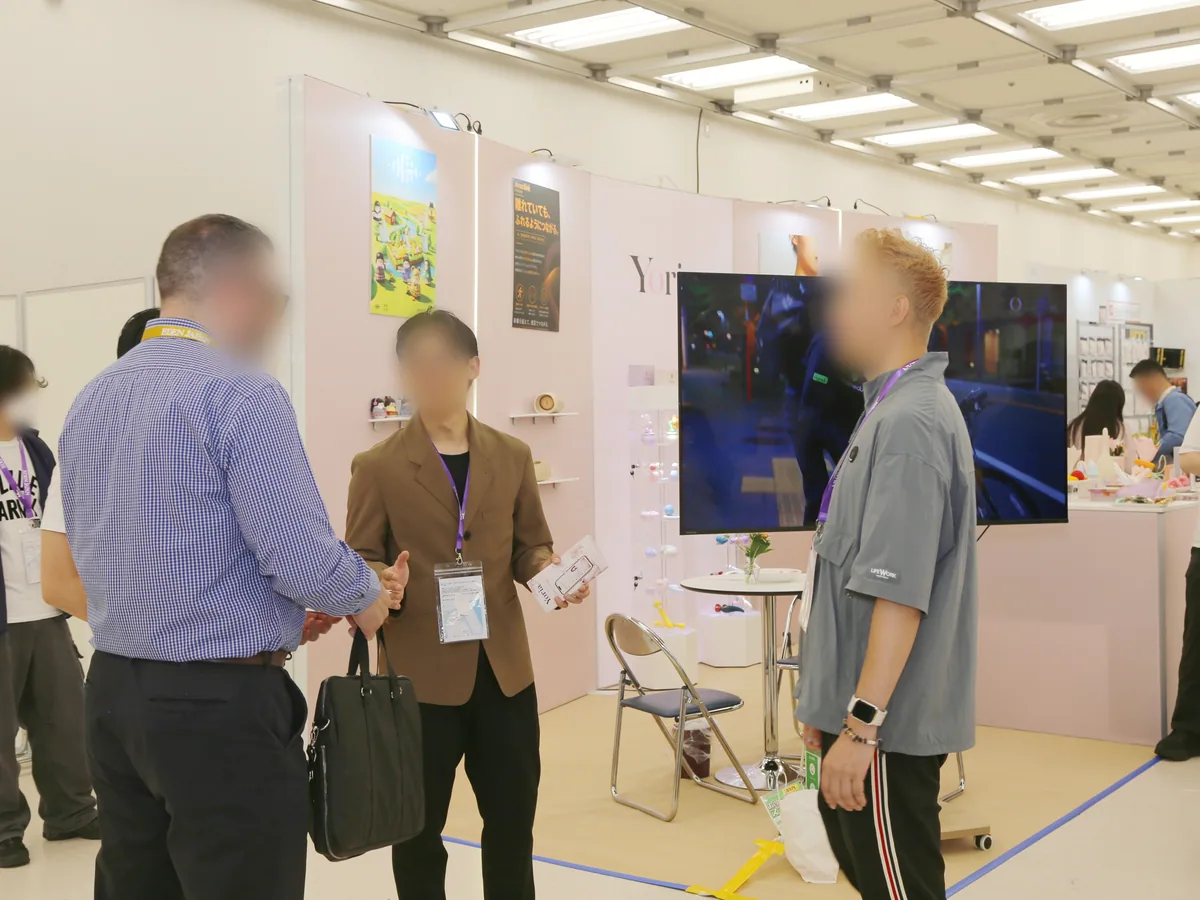 ブースの前で打ち合わせる来場者と出展社